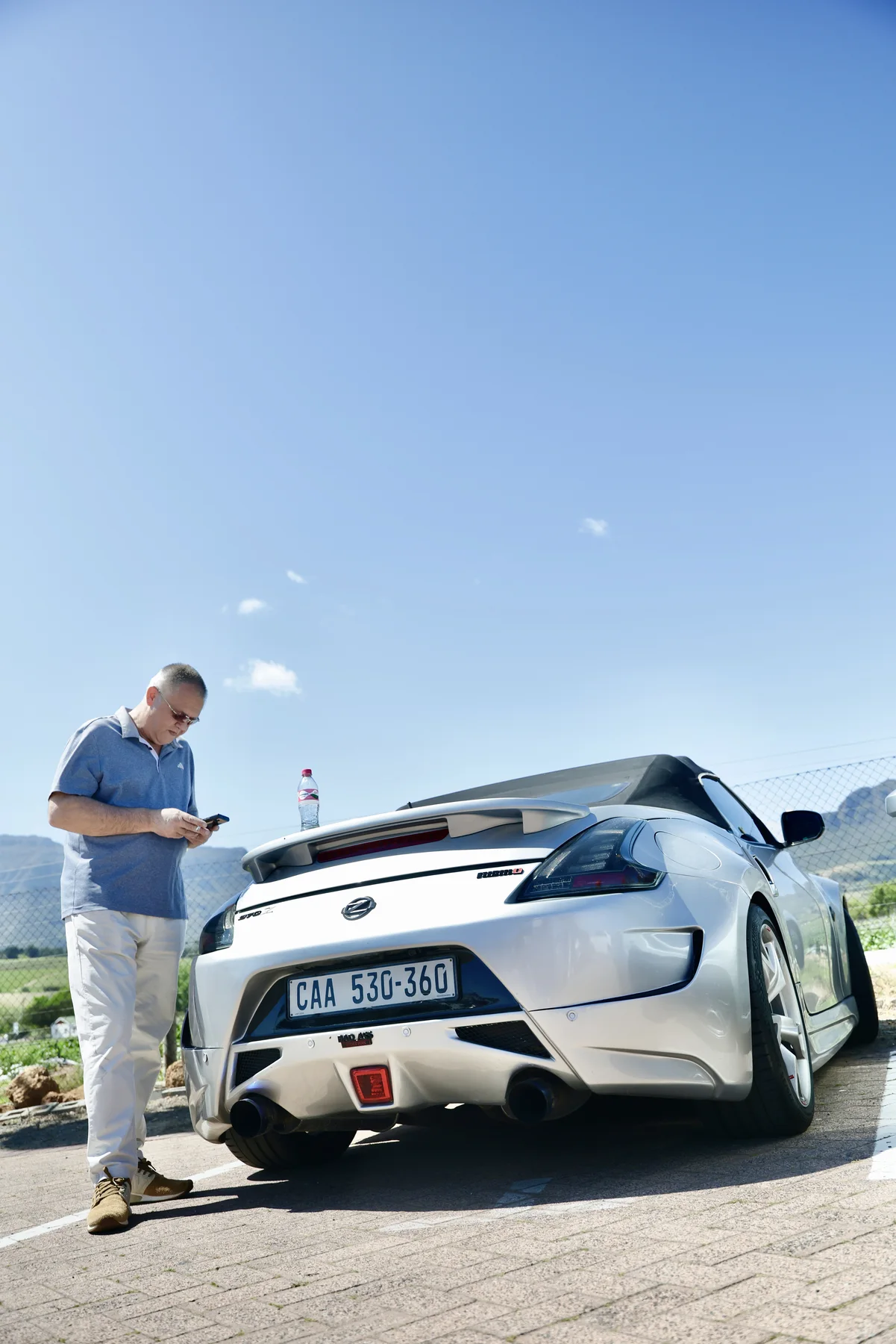 Man standing beside a silver Z